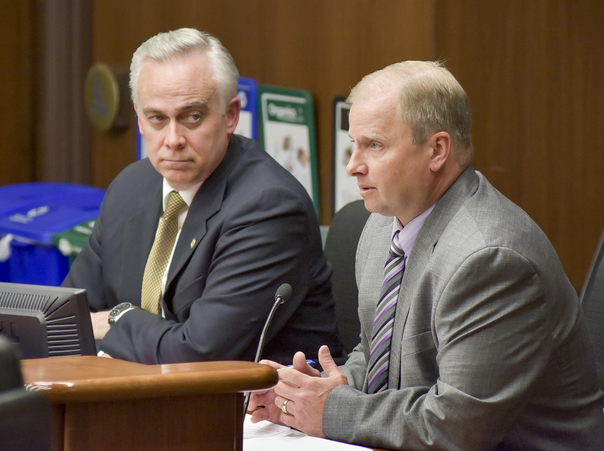 Jeff Bradley, president of the Mental Health Providers Association of Minnesota, testifies before the House Health and Human Services Finance Committee March 23 in support of a bill sponsored by Rep. Tony Albright, left, that would modify group residential housing eligibility. Photo by Andrew VonBank